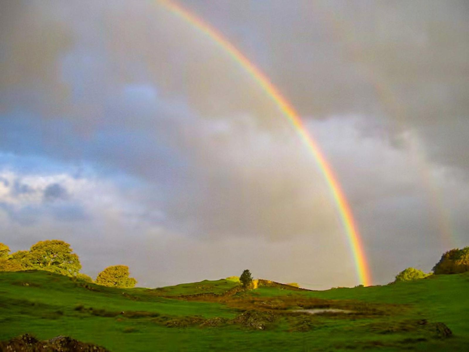 A rainbow over green Lakeland fells